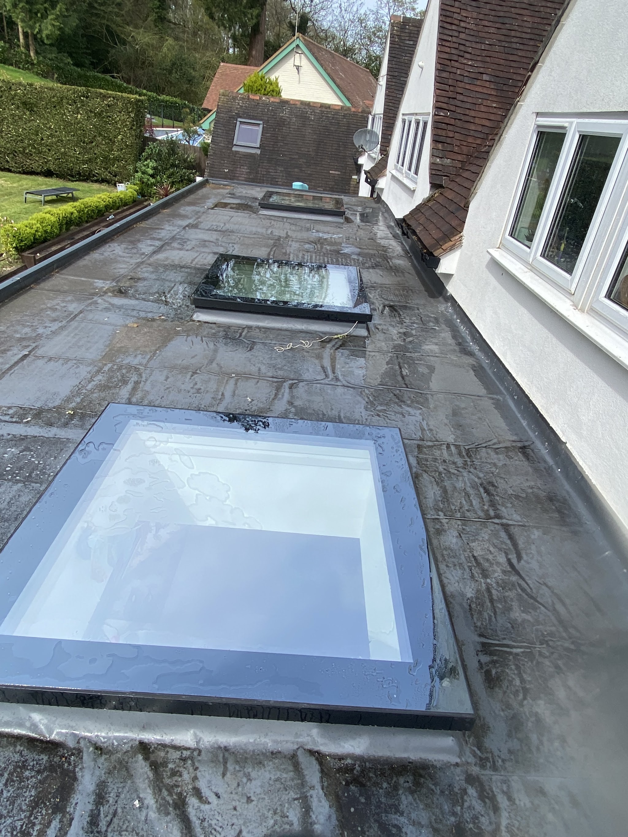 A flat roof with two roof lanterns, cleaned