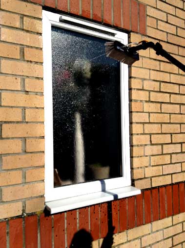 The brush rinsing a window with purified water