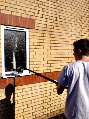 Spencer rinsing a ground floor window