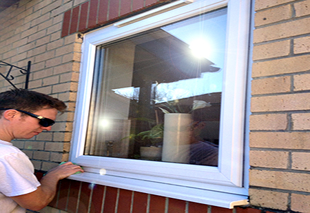 Spencer wiping down a window sill